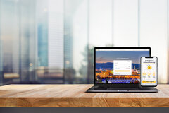 1157789033 Modern computer,laptop with blank screen on counter bar(retail store shop)and window view